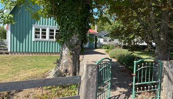 Charmigt hus på lantlig gård nära sjö och natur