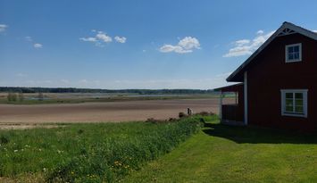 Torp/stuga med fin utsikt över sjö och fält