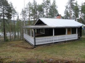 Timber cottage with forest plot and lake view