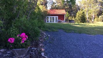 Newly built cottage near the sea with a rowing boa