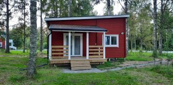 Wooden cottage nestled on the edge of the forest