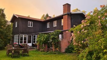 Large countryhouse next to forests and a lake