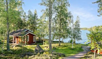 Sjönära stuga med privat sandstrand och brygga